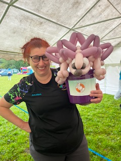 woman holding hedghog balloon sculpture
